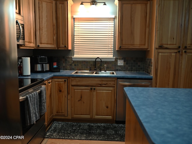 kitchen with decorative backsplash, stainless steel appliances, and sink