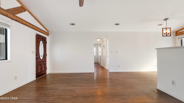 entryway featuring ceiling fan with notable chandelier, dark hardwood / wood-style floors, and lofted ceiling