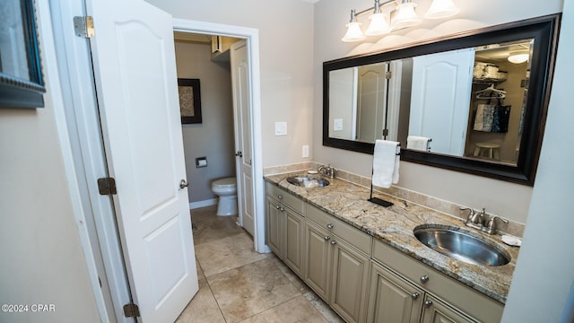 bathroom featuring tile patterned flooring, vanity, and toilet