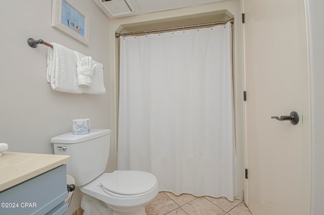 bathroom with tile patterned flooring, vanity, and toilet