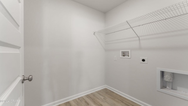 laundry area with electric dryer hookup, hookup for a washing machine, and wood-type flooring