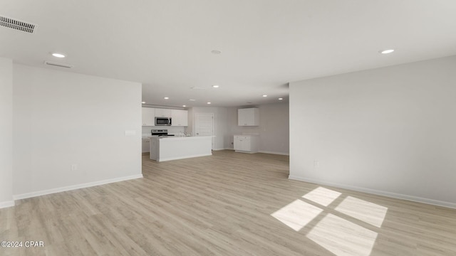 unfurnished living room featuring light wood-type flooring