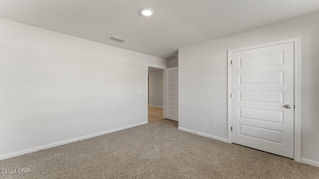 empty room with light colored carpet