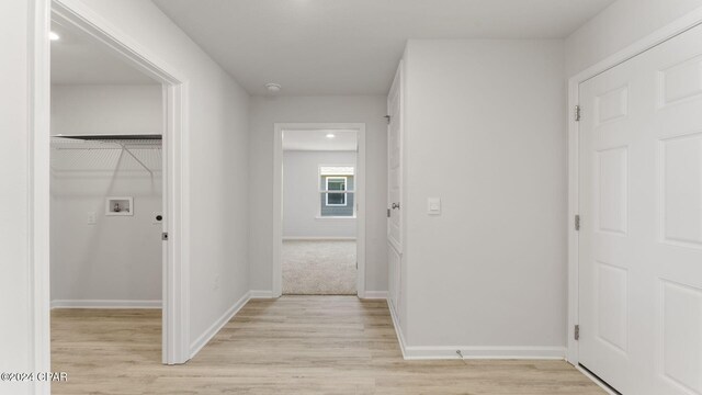 corridor featuring light hardwood / wood-style flooring