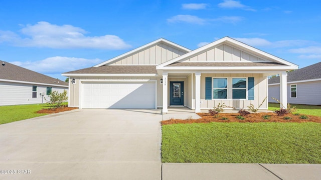 view of front of home featuring a porch, a garage, and a front yard