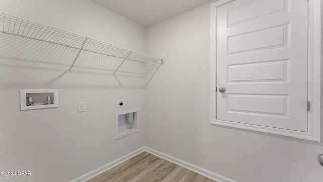 laundry room with electric dryer hookup, washer hookup, and light hardwood / wood-style floors