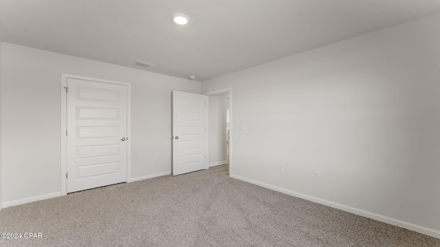 unfurnished bedroom with carpet and a closet