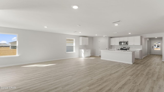 unfurnished living room with light wood-type flooring