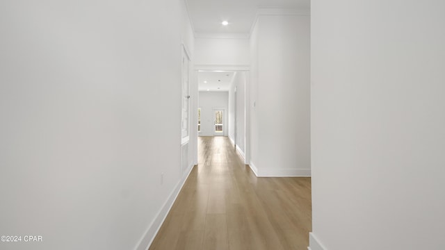 corridor featuring light hardwood / wood-style floors and ornamental molding