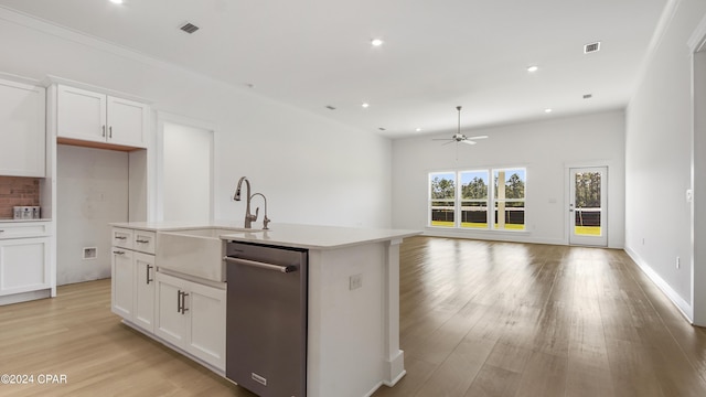 kitchen featuring white cabinets, sink, a center island with sink, and stainless steel dishwasher