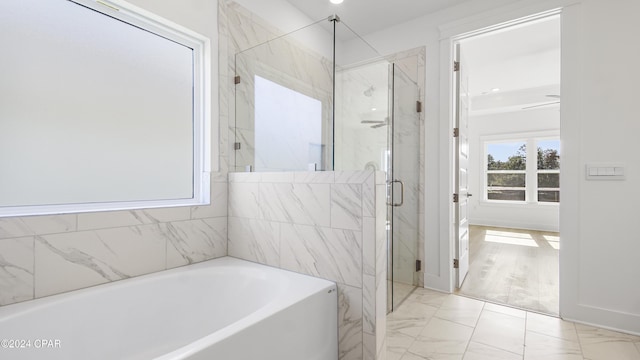 bathroom featuring shower with separate bathtub