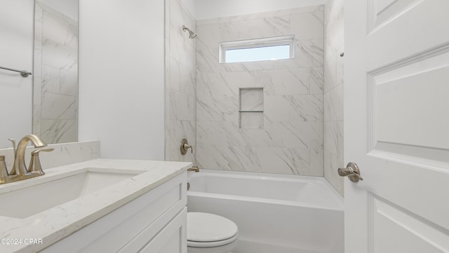 full bathroom featuring vanity, tiled shower / bath combo, and toilet