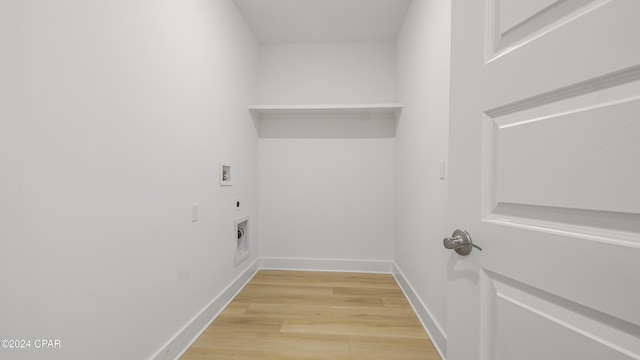 washroom with hookup for an electric dryer, hookup for a washing machine, and light hardwood / wood-style flooring