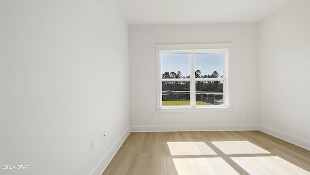 empty room with light hardwood / wood-style flooring