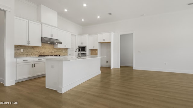 kitchen with white cabinets, a center island with sink, and dark hardwood / wood-style floors