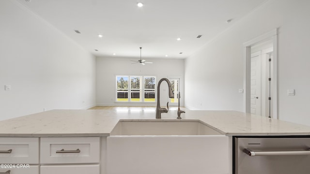 kitchen with sink, crown molding, ceiling fan, light stone countertops, and white cabinetry