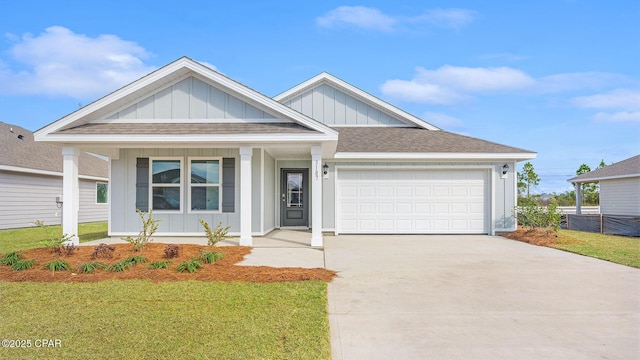 view of front of property featuring a garage and a front yard