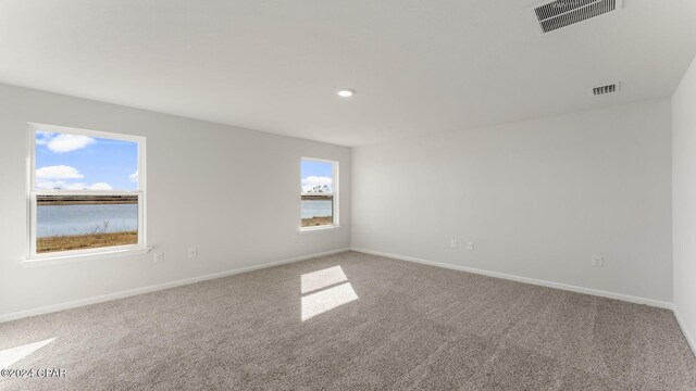 unfurnished bedroom featuring light carpet and connected bathroom