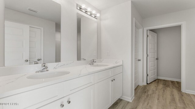 bathroom with a shower and hardwood / wood-style floors