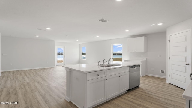 kitchen with stainless steel dishwasher, sink, a center island with sink, light hardwood / wood-style floors, and white cabinetry