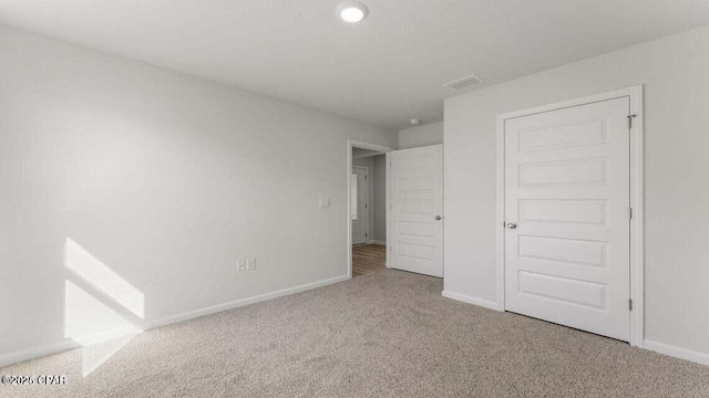 unfurnished bedroom with light carpet