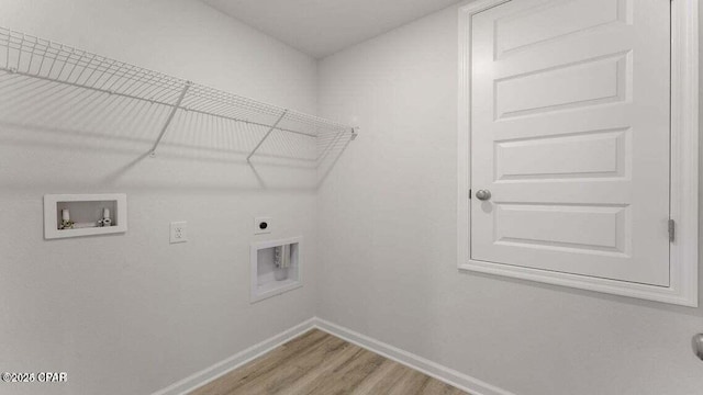 laundry room with electric dryer hookup, hookup for a washing machine, and light wood-type flooring