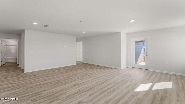 unfurnished room with light hardwood / wood-style floors