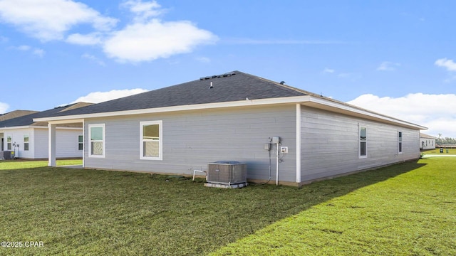 back of house featuring a yard and central AC