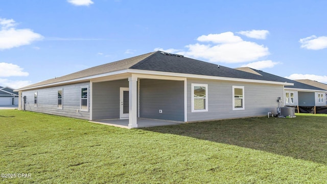 back of property with a yard and a patio