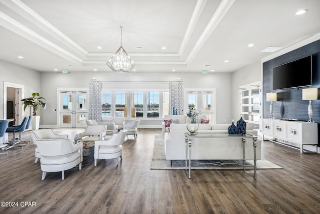 living room featuring a tray ceiling, ornamental molding, and dark hardwood / wood-style floors