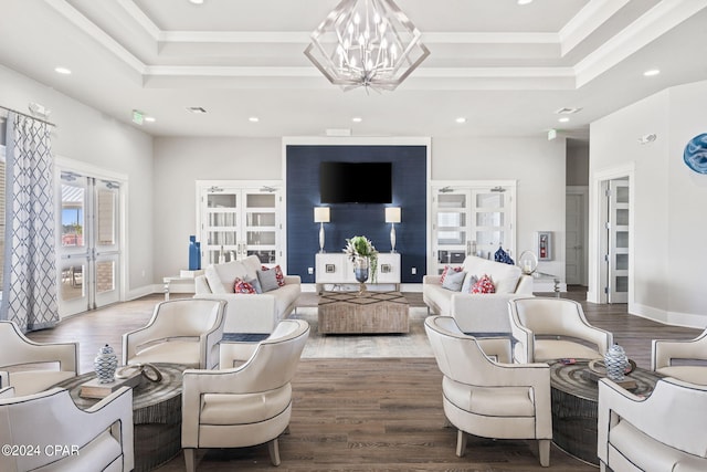 living room with french doors, wood-type flooring, ornamental molding, and a tray ceiling