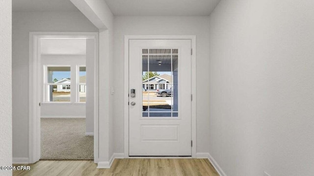 doorway to outside with a wealth of natural light and light hardwood / wood-style floors