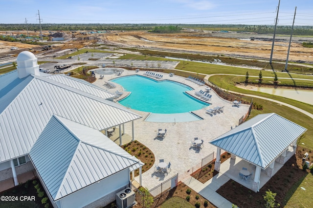 view of pool featuring a gazebo, a water view, and a patio area