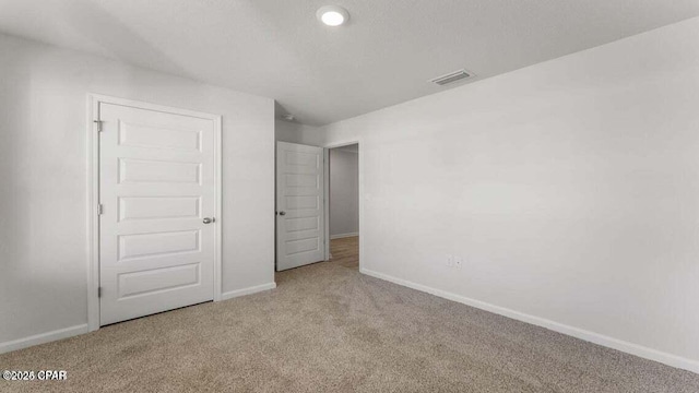 unfurnished bedroom with light carpet