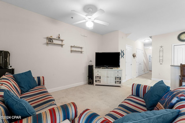 living area featuring ceiling fan, baseboards, and light colored carpet