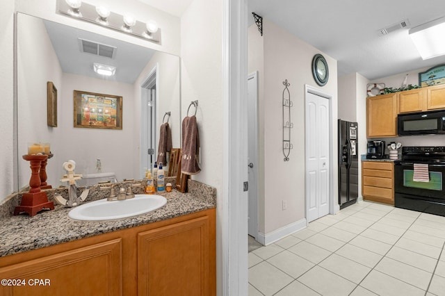 bathroom with tile patterned floors, vanity, and toilet