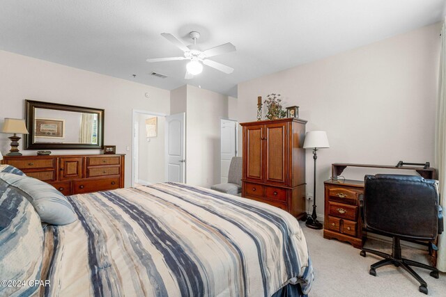 bedroom featuring light colored carpet and ceiling fan