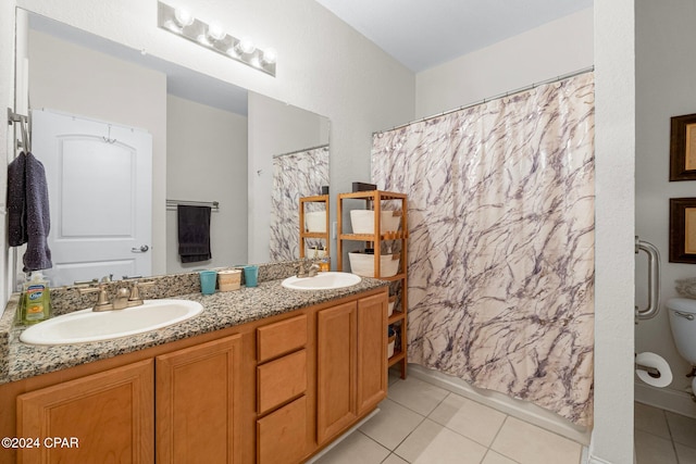 bathroom featuring tile patterned floors, vanity, and toilet