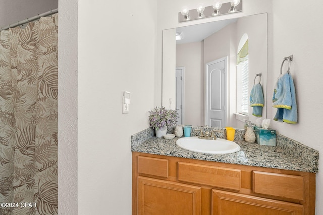 bathroom featuring a shower with shower curtain and vanity