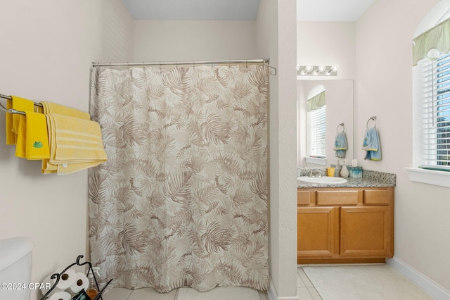 full bathroom featuring toilet, baseboards, vanity, and tile patterned floors