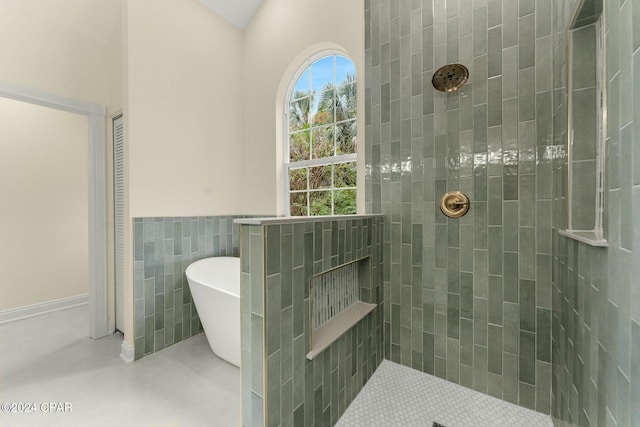 bathroom featuring separate shower and tub and tile walls