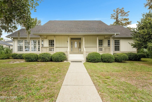 view of front of property with a porch and a front lawn