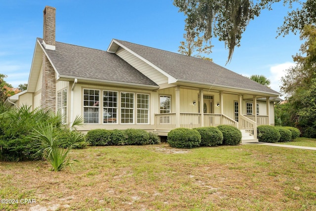 view of front of property with a front yard and a porch