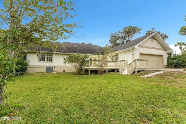 back of property featuring a lawn, central air condition unit, and a deck