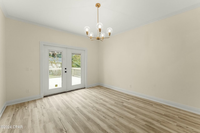 unfurnished room with french doors, an inviting chandelier, ornamental molding, and light hardwood / wood-style flooring