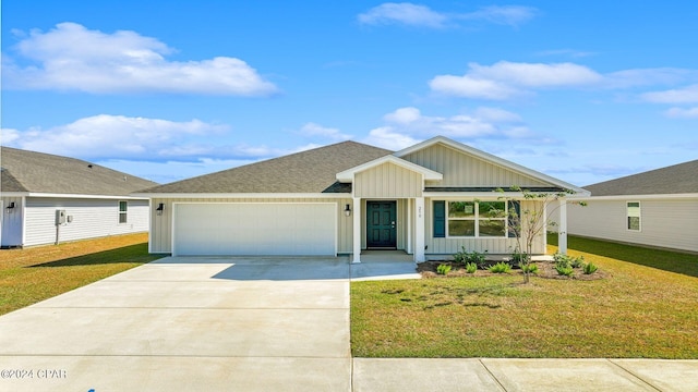 view of front of property featuring a garage and a front yard