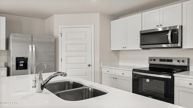 kitchen featuring white cabinetry, sink, and appliances with stainless steel finishes