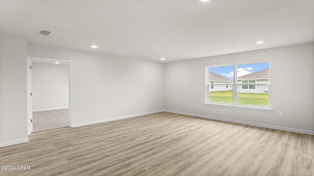 spare room with light hardwood / wood-style flooring