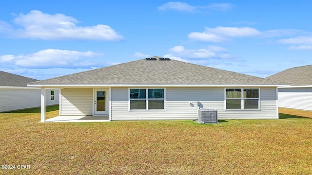 back of house featuring a lawn, cooling unit, and a patio