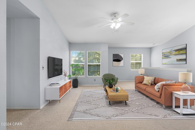 living room featuring light colored carpet and ceiling fan